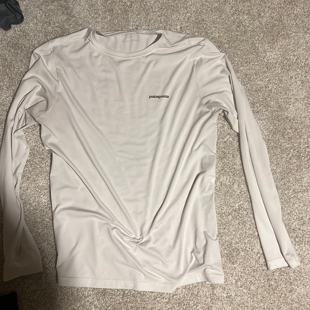 White Patagonia with colorful fish hook on back